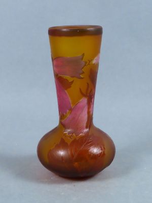 a glass vase with flowers on it on a table