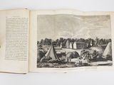 an open book with a picture of a village in the middle of it