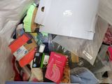a pile of items in a plastic bag with a laptop on top of it