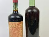 two bottles of wine sitting next to each other on a white surface