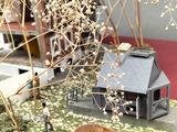 a model of a house on a table with a red cloth