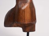 wooden sculpture of a woman ' s head on a black stand