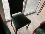 a green chair sitting in front of a sliding glass door