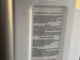 a white refrigerator with a yellow sticker on it