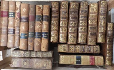 a lot of old books on a shelf in the room