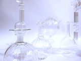 three glass vases sitting next to each other on a table