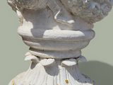 a close up of a white vase with a bird on it