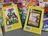 a lot of comic books that are sitting on a table