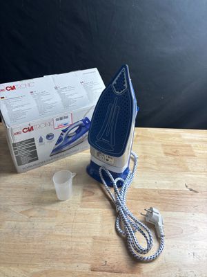 an image of a blue and white iron sitting on top of a wooden table