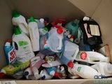 a cardboard box full of cleaning products and other household items