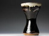 a black and white vase sitting on a table