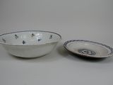 a white bowl and a blue and white bowl on a table