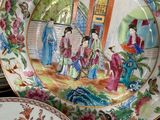 a plate with a painting on it sitting on a table