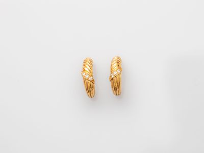 a pair of gold and diamond earrings