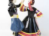 two figurines of a man and a woman dancing
