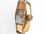 an image of a close up of a wrist watch on a white surface