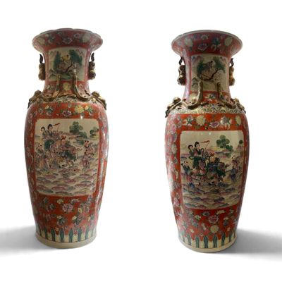 pair of chinese vases with asian scenes on them against a white background