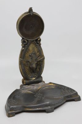 brass plate with a bird on it and a mirror on top of it