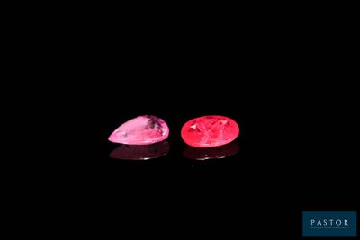 pair of pink tourmaline gems on a black background