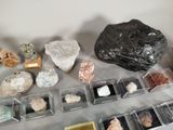 a lot of different rocks and minerals on the table