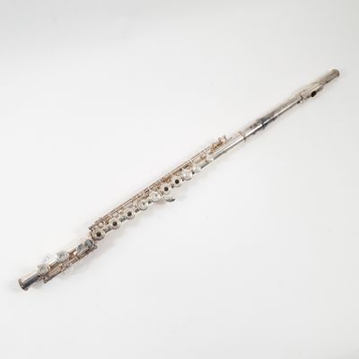 an old silver flute on a white surface with a white background