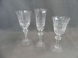 three wine glasses sitting next to each other on a table