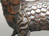 a bronze statue of a ram with a long horn
