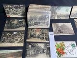 many old postcards on a table with a bunch of them
