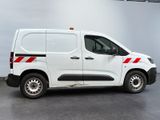 a white van with red stripes parked in a garage