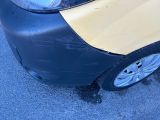 a car that has been painted yellow and is parked in the street
