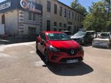 a red car parked in front of a building in a parking lot