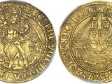 a gold coin with an image of a ship on it