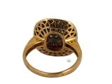 an image of a gold ring with a garnet stone in the center