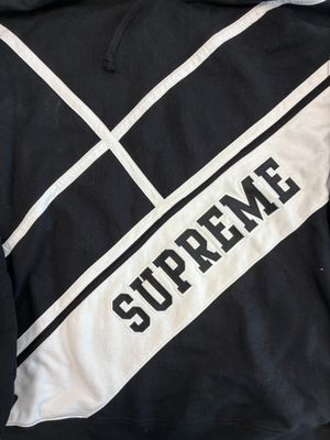 black and white hoodie with the word supreme on it