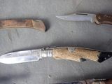 several different types of knives are displayed on a table