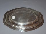 a silver plate on a table with a tag on it