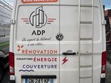 a van that has a ladder on the back of it