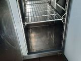 an open oven door in a kitchen with tile flooring