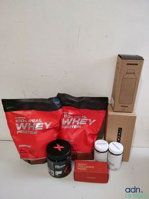 the contents of the whey protein package are laid out on the counter