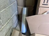 a pile of boxes and boxes on the floor next to a brick wall