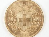 a close up of a gold coin with a coat of arms on it