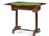 a small table with a green top and wooden legs