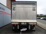 a truck parked in a parking lot with a sign on the back