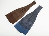 three ties are laid out on top of each other on a white surface