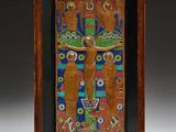 a wooden plaque depicting a man on a cross with flowers
