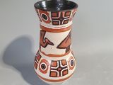 a small vase with a design on it on a table