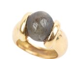 an image of a gold ring with a black stone in it