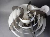 underside view of a white fan on a table with a black background