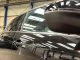 a car that is parked in a garage with its door open