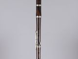 a close up of a wooden flute on a clear surface
